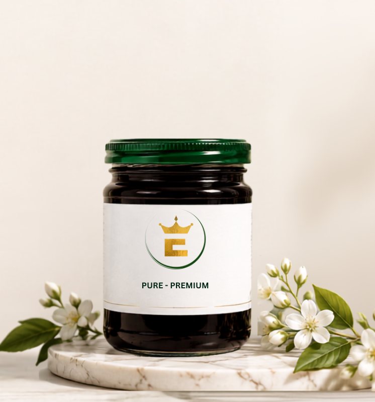 A jar of Queen E's Heirr jam on a marble stand with white blossoms